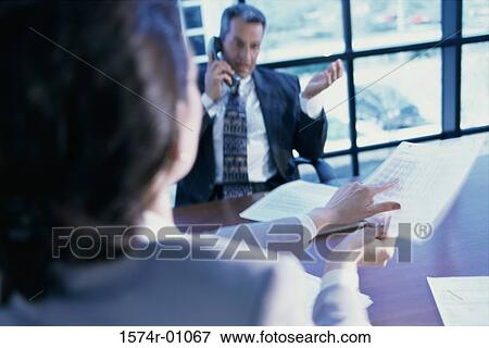 Two business executives in a discussion View Large Photo Image Stock Photo - Two business executives in a discussion. Fotosearch