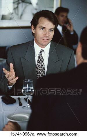 Two businessmen discussing in a restaurant View Large Photo Image Stock Image - Two businessmen discussing in a restaurant. Fotosearch