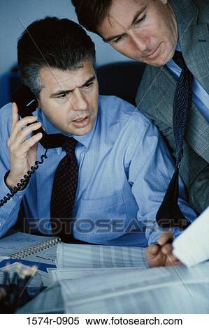 Two businessmen discussing in an office View Large Photo Image Stock Photography - Two businessmen discussing in an office. Fotosearch