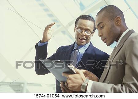 Two businessmen discussing View Large Photo Image Picture - Two businessmen discussing. Fotosearch