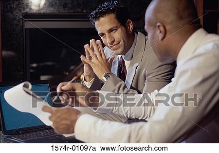 Two businessmen discussing View Large Photo Image Stock Image - Two businessmen discussing. Fotosearch