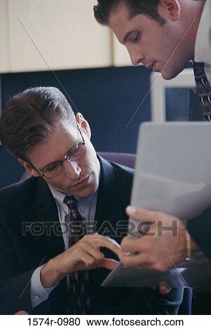 Two businessmen discussing View Large Photo Image Stock Image - Two businessmen discussing. Fotosearch