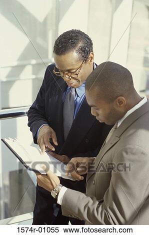 Two businessmen discussing View Large Photo Image Stock Photography - Two businessmen discussing. Fotosearch
