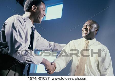 Two businessmen shaking hands View Large Photo Image Stock Photo - Two businessmen shaking hands. Fotosearch
