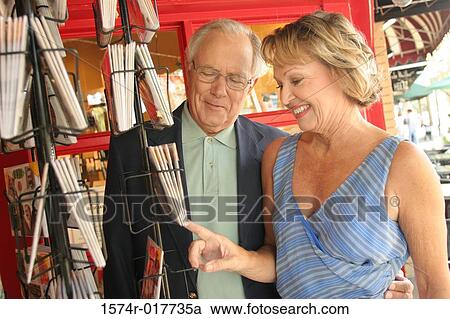 Senior couple looking at books in a bookstore View Large Photo Image Stock Image - Senior couple looking at books in a bookstore. Fotosearch