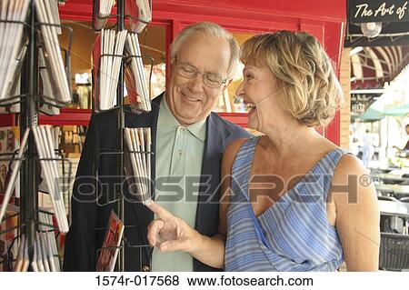 Stock Photo - Senior couple looking at books in a bookstore. Fotosearch