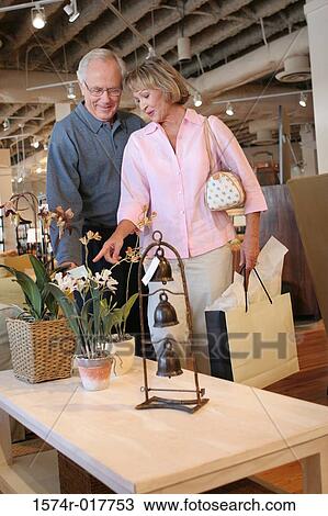 Senior couple looking at potted plants in a store View Large Photo Image Stock Image - Senior couple looking at potted plants in a store. Fotosearch