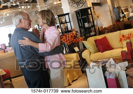 Side profile of a senior couple dancing in a furniture store View Large Photo Image Stock Photo - Side profile of a senior couple dancing in a furniture store. Fotosearch
