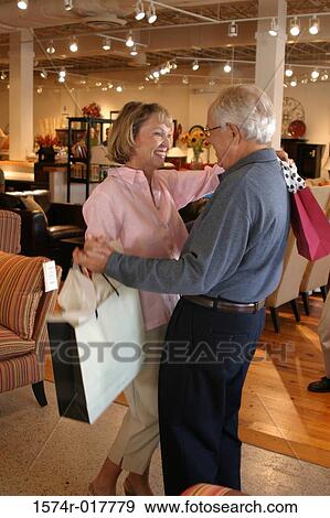 Side profile of a senior couple dancing in a furniture store View Large Photo Image Stock Photo - Side profile of a senior couple dancing in a furniture store. Fotosearch
