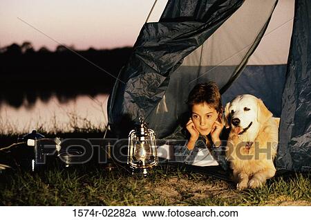Boy camping in a tent with his dog View Large Photo Image Stock Image - Boy camping in a tent with his dog. Fotosearch
