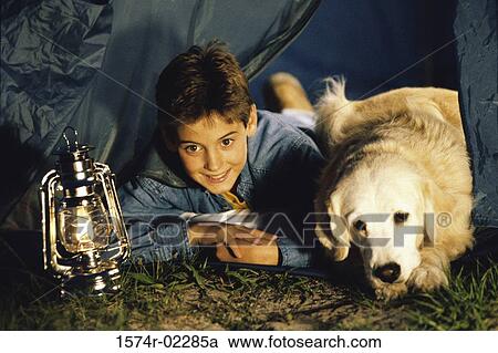 Boy camping in a tent with his dog View Large Photo Image Stock Image - Boy camping in a tent with his dog. Fotosearch