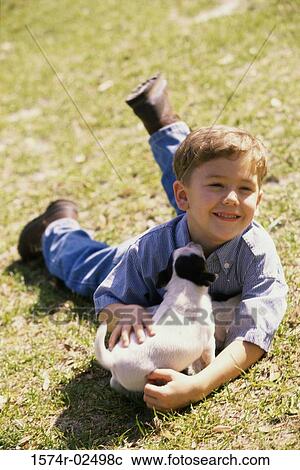 Boy playing with puppies View Large Photo Image Stock Image - Boy playing with puppies. Fotosearch