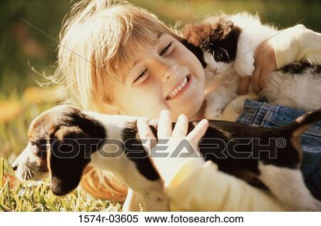 Close-up of a girl holding a puppy and a kitten View Large Photo Image Stock Photography - Close-up of a girl holding a puppy and a kitten. Fotosearch