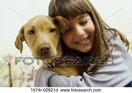 Close-up of a girl holding her dog View Large Photo Image Stock Image - Close-up of a girl holding her dog. Fotosearch