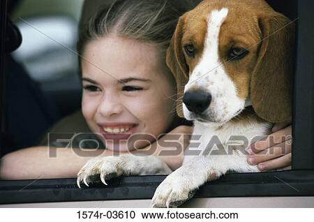 Close-up of a girl holding her dog View Large Photo Image Stock Image - Close-up of a girl holding her dog. Fotosearch