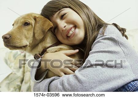 Close-up of a girl holding her dog View Large Photo Image Stock Photograph - Close-up of a girl holding her dog. Fotosearch