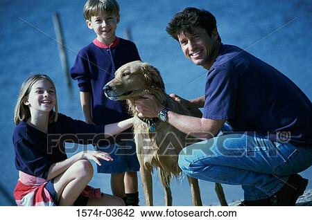 Father and his son and daughter playing with their dog View Large Photo Image Stock Image - Father and his son and daughter playing with their dog. Fotosearch