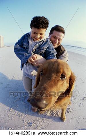 Father and his son playing with their dog on the beach View Large Photo Image Stock Image - Father and his son playing with their dog on the beach. Fotosearch