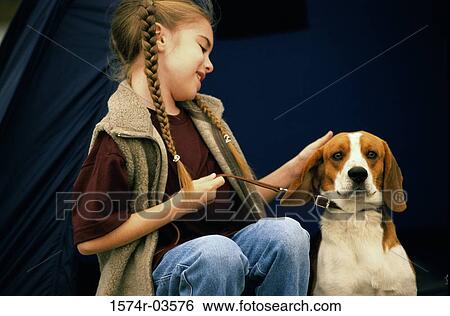 Stock Photograph - Girl sitting with her dog. Fotosearch