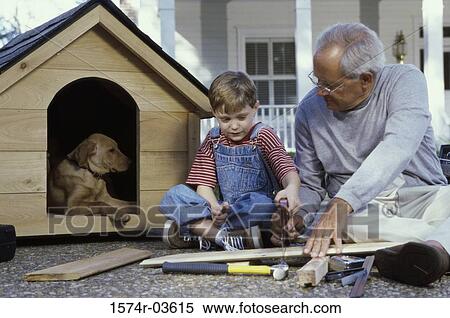 Grandfather and his grandson building a kennel View Large Photo Image Stock Photography - Grandfather and his grandson building a kennel. Fotosearch
