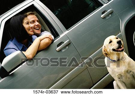 Stock Photo - Mid adult couple sitting in a car. Fotosearch