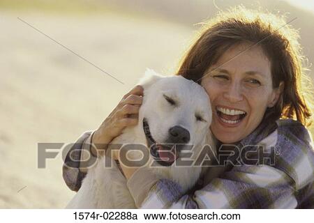 Mid adult woman hugging her dog View Large Photo Image Stock Image - Mid adult woman hugging her dog. Fotosearch