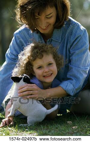 Mother and her daughter playing with a puppy View Large Photo Image Stock Image - Mother and her daughter playing with a puppy. Fotosearch