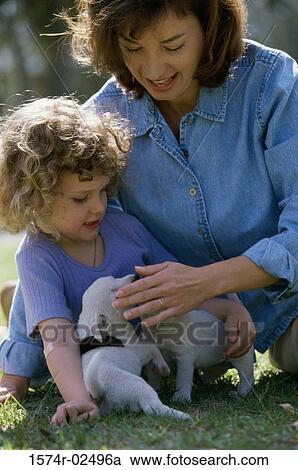 Mother and her daughter playing with puppies View Large Photo Image Stock Image - Mother and her daughter playing with puppies. Fotosearch