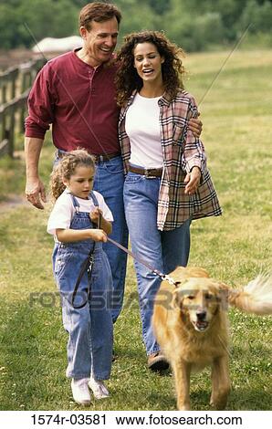 Parents and their daughter walking their dog View Large Photo Image Stock Image - Parents and their daughter walking their dog. Fotosearch