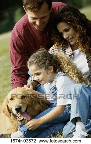 Parents with their daughter and a dog View Large Photo Image Stock Image - Parents with their daughter and a dog. Fotosearch