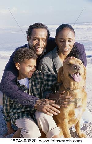 Parents with their son holding a dog View Large Photo Image Stock Image - Parents with their son holding a dog. Fotosearch