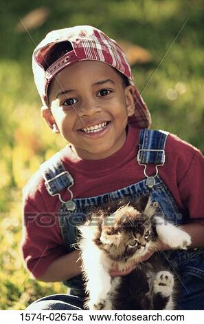 Portrait of a boy holding a cat View Large Photo Image Stock Image - Portrait of a boy holding a cat. Fotosearch