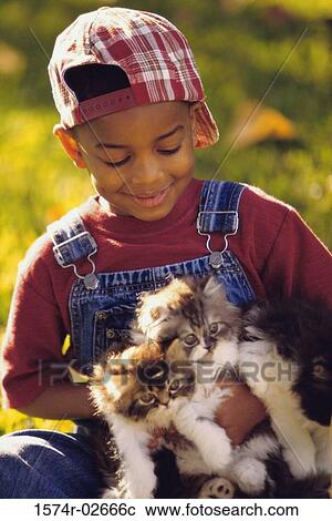 Portrait of a boy holding cats View Large Photo Image Stock Image - Portrait of a boy holding cats. Fotosearch