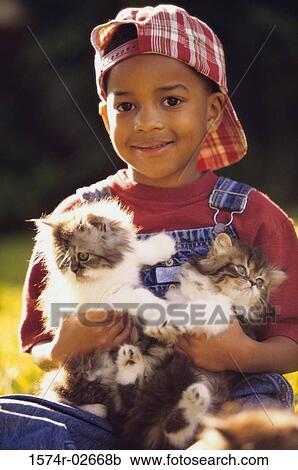 Portrait of a boy holding cats View Large Photo Image Stock Image - Portrait of a boy holding cats. Fotosearch