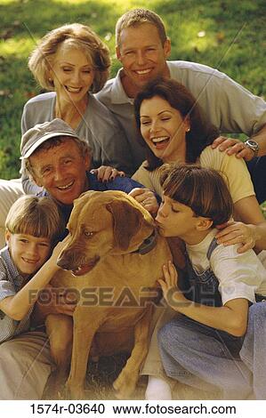 Portrait of a family sitting together on a lawn with their dog View Large Photo Image Stock Image - Portrait of a family sitting together on a lawn with their dog. Fotosearch