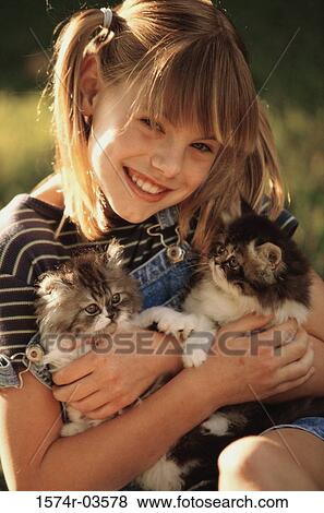 Portrait of a girl holding cats View Large Photo Image Stock Photo - Portrait of a girl holding cats. Fotosearch