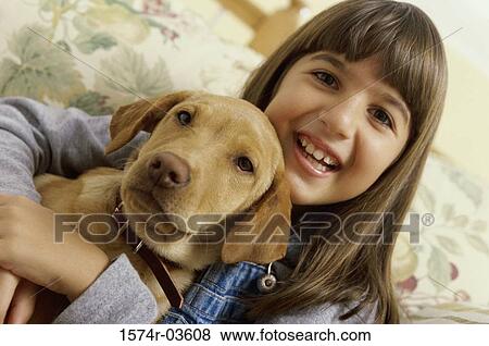 Portrait of a girl holding her dog View Large Photo Image Stock Photo - Portrait of a girl holding her dog. Fotosearch