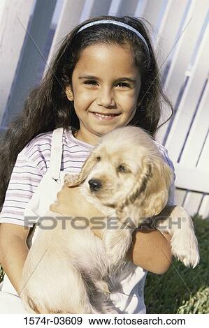 Portrait of a girl holding her dog View Large Photo Image Stock Photo - Portrait of a girl holding her dog. Fotosearch