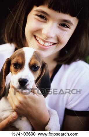 Portrait of a girl holding her puppy View Large Photo Image Stock Image - Portrait of a girl holding her puppy. Fotosearch