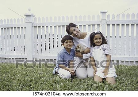 Portrait of a mother with her son and daughter holding a puppy View Large Photo Image Stock Image - Portrait of a mother with her son and daughter holding a puppy. Fotosearch