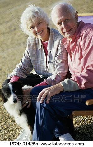 Portrait of a senior couple sitting with their dog View Large Photo Image Stock Image - Portrait of a senior couple sitting with their dog. Fotosearch