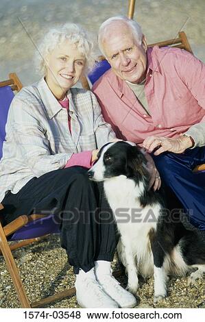 Portrait of a senior couple sitting with their dog View Large Photo Image Stock Photo - Portrait of a senior couple sitting with their dog. Fotosearch