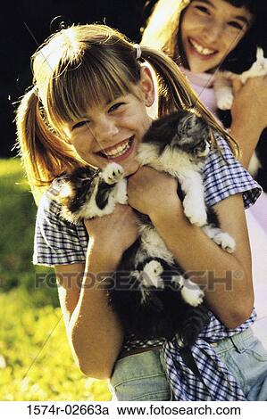 Portrait of two girls cuddling kittens View Large Photo Image Stock Image - Portrait of two girls cuddling kittens. Fotosearch