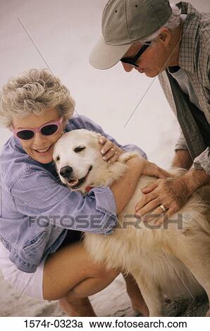 Senior couple hugging their dog View Large Photo Image Stock Image - Senior couple hugging their dog. Fotosearch