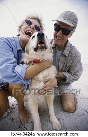 Senior couple hugging their dog View Large Photo Image Stock Image - Senior couple hugging their dog. Fotosearch