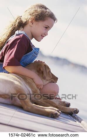 Side profile of a girl sitting with her dog View Large Photo Image Stock Image - Side profile of a girl sitting with her dog. Fotosearch
