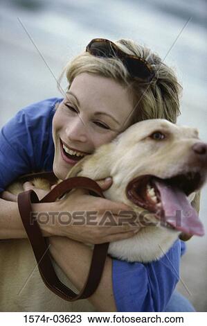 Young woman hugging her dog View Large Photo Image Stock Image - Young woman hugging her dog. Fotosearch
