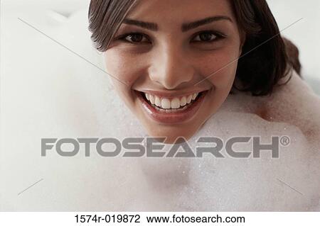 Close-up of a young woman taking a bubble bath View Large Photo Image Stock Image - Close-up of a young woman taking a bubble bath. Fotosearch