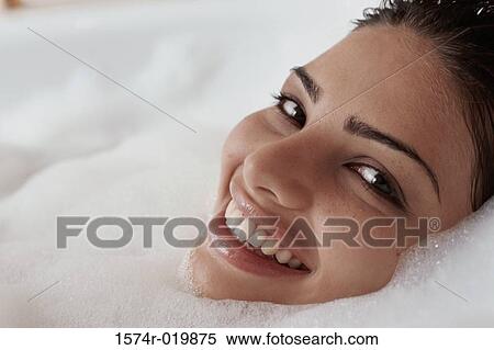 Close-up of a young woman taking a bubble bath View Large Photo Image Stock Photography - Close-up of a young woman taking a bubble bath. Fotosearch