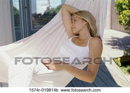 High angle view of a young woman lying in a hammock View Large Photo Image Stock Image - High angle view of a young woman lying in a hammock. Fotosearch